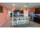 Open concept kitchen features granite countertops, a large island with seating, and modern appliances and dark cabinets at 5934 Shingle Creek Rd, Lakeland, FL 33811
