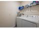 Bright laundry room equipped with a modern washer and dryer, plus storage shelves at 5934 Shingle Creek Rd, Lakeland, FL 33811