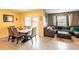 Open-concept living and dining areas with tile flooring and sliding door at 5934 Shingle Creek Rd, Lakeland, FL 33811