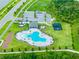 Aerial view of the community pool featuring resort-style amenities, playground and ample parking at 5934 Shingle Creek Rd, Lakeland, FL 33811