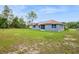 View of backyard showing a house with solar panels on the roof at 8628 Sw 133Rd Lane Rd, Ocala, FL 34473