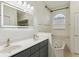 Bright bathroom with double sinks, a large mirror, and a soaking tub under an arched window at 8628 Sw 133Rd Lane Rd, Ocala, FL 34473