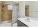 Bathroom featuring a shower-tub combo with tile surround, a single vanity and neutral tones at 8628 Sw 133Rd Lane Rd, Ocala, FL 34473