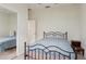 Bedroom featuring a blue bed, a ceiling fan, mirrored closet doors, and ample natural light at 8628 Sw 133Rd Lane Rd, Ocala, FL 34473