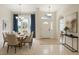 Bright dining room featuring a large window, dining table set, and an entry way at 8628 Sw 133Rd Lane Rd, Ocala, FL 34473