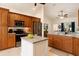 Bright kitchen with stainless steel appliances, center island, and wooden cabinets at 8628 Sw 133Rd Lane Rd, Ocala, FL 34473