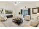 Spacious living room with comfortable seating, neutral tones, and a sliding door to the patio at 8628 Sw 133Rd Lane Rd, Ocala, FL 34473