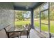 A screened patio with a glass table for outdoor dining with backyard views at 8628 Sw 133Rd Lane Rd, Ocala, FL 34473