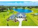 Breathtaking aerial view of a luxury estate with manicured lawns and a picturesque lake backdrop at 12902 Sw 138Th Loop, Dunnellon, FL 34432