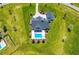Aerial shot of elegant home and pool, adorned with decorative landscaping on a well manicured lawn at 12902 Sw 138Th Loop, Dunnellon, FL 34432