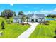 Aerial view of a stunning home with an expansive lawn, a private pond, and lush landscaping, creating a serene setting at 12902 Sw 138Th Loop, Dunnellon, FL 34432