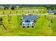 Beautiful home with a refreshing pool and patio, surrounded by lush green landscaping and a picturesque pond at 12902 Sw 138Th Loop, Dunnellon, FL 34432