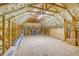 Large unfinished attic storage space with spray foam insulation and wood beam framing offering ample storage at 12902 Sw 138Th Loop, Dunnellon, FL 34432