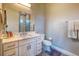 Neat bathroom with a vanity, granite countertop, stylish mirror, and towels, with a tiled shower at 12902 Sw 138Th Loop, Dunnellon, FL 34432