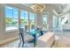 Bright dining room with glass table, modern lighting, and a view of the outdoor pool area at 12902 Sw 138Th Loop, Dunnellon, FL 34432