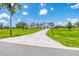 The beautiful front of a home showing the driveway, landscaping, and architectural details in a lush, green setting at 12902 Sw 138Th Loop, Dunnellon, FL 34432