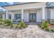 Charming front entrance with double doors, stone-accented columns, and well-manicured landscaping creating an inviting curb appeal at 12902 Sw 138Th Loop, Dunnellon, FL 34432