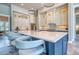 Kitchen features a large island with seating, pendant lighting, and modern two-tone cabinets at 12902 Sw 138Th Loop, Dunnellon, FL 34432