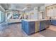 Open-concept kitchen with island, stainless steel appliances, and view of the living room at 12902 Sw 138Th Loop, Dunnellon, FL 34432