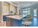Modern kitchen featuring a large island with seating, contemporary lighting, and sleek design at 12902 Sw 138Th Loop, Dunnellon, FL 34432