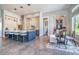 Modern kitchen with island seating, pendant lighting, and adjacent dining area at 12902 Sw 138Th Loop, Dunnellon, FL 34432
