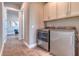 Laundry room with appliances and cabinetry, offering a functional and organized space for chores at 12902 Sw 138Th Loop, Dunnellon, FL 34432
