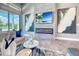 Open living room featuring stone fireplace, modern decor, and sliding glass doors at 12902 Sw 138Th Loop, Dunnellon, FL 34432