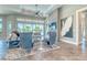 Chic living room with a stone accent wall, modern furniture, and ample natural light at 12902 Sw 138Th Loop, Dunnellon, FL 34432