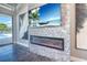 Living room with stone accent wall, fireplace, and glass doors with outdoor views at 12902 Sw 138Th Loop, Dunnellon, FL 34432