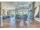 Open-concept living area featuring modern decor, stone fireplace, and scenic outdoor views at 12902 Sw 138Th Loop, Dunnellon, FL 34432