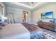 This main bedroom features a TV and a modern dresser at 12902 Sw 138Th Loop, Dunnellon, FL 34432