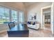 The office features an elegant sofa and views of the outdoors at 12902 Sw 138Th Loop, Dunnellon, FL 34432