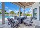 Covered outdoor seating area features pavers, a fireplace and a view of the pool, lake, and the exterior of the home at 12902 Sw 138Th Loop, Dunnellon, FL 34432