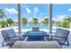 Outdoor patio with a fire pit, comfortable seating, and pool views at 12902 Sw 138Th Loop, Dunnellon, FL 34432
