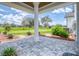 Charming outdoor patio with stone pavers, manicured landscaping, and serene views of the surrounding greenery at 12902 Sw 138Th Loop, Dunnellon, FL 34432