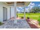 Beautiful outdoor patio with columns, stone pavers, and view of the landscaped yard and the home in the distance at 12902 Sw 138Th Loop, Dunnellon, FL 34432