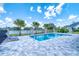 A backyard pool with a safety fence and a peaceful lake view, ideal for relaxing in the Florida sunshine at 12902 Sw 138Th Loop, Dunnellon, FL 34432
