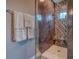 Modern tiled shower featuring a glass door, decorative tile accent, and a window for natural light at 12902 Sw 138Th Loop, Dunnellon, FL 34432