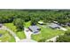 Aerial view of a blue home with outbuildings and a pool on a large lot at 3229 Gardner Oaks Ln, Lakeland, FL 33810
