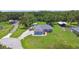 Blue home with outbuildings and pool, nestled on large lot in a forested area at 3229 Gardner Oaks Ln, Lakeland, FL 33810