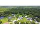 Aerial view of several homes in a lush forest area with pond at 3229 Gardner Oaks Ln, Lakeland, FL 33810