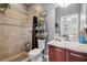 This bathroom has a tile shower, neutral walls and flooring, and vanity with mirror at 3229 Gardner Oaks Ln, Lakeland, FL 33810
