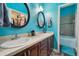 Bright bathroom with double vanity, large mirror and a view of the shower and walk in closet at 3229 Gardner Oaks Ln, Lakeland, FL 33810