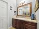 A well lit bathroom featuring a large vanity with drawers and cabinet space and a large mirror at 3229 Gardner Oaks Ln, Lakeland, FL 33810