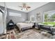 Bedroom with modern flooring, white walls, two windows and a ceiling fan at 3229 Gardner Oaks Ln, Lakeland, FL 33810