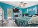 A bright bedroom with teal walls features a fireplace and French doors to the backyard at 3229 Gardner Oaks Ln, Lakeland, FL 33810