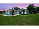 Charming blue home with well-manicured lawn, patio, and lush landscaping at 3229 Gardner Oaks Ln, Lakeland, FL 33810