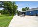 Long driveway leads to house with large trailer parked, and garage in the back at 3229 Gardner Oaks Ln, Lakeland, FL 33810