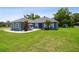 Charming blue home with well-manicured lawn, patio, and lush landscaping at 3229 Gardner Oaks Ln, Lakeland, FL 33810