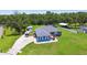 Bright blue home featuring a spacious yard, convenient outbuildings and a long driveway at 3229 Gardner Oaks Ln, Lakeland, FL 33810